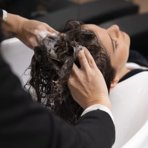woman-getting-treatment-hairdresser-shop
